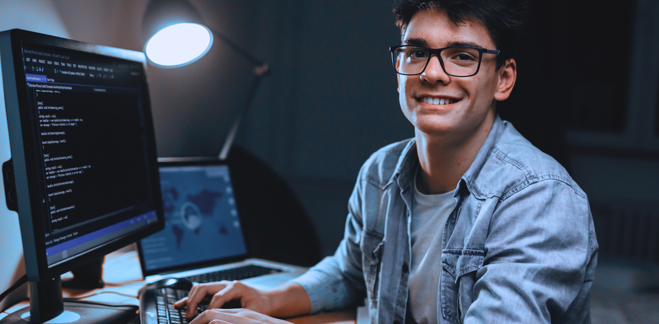 Smiling programmer working on code.